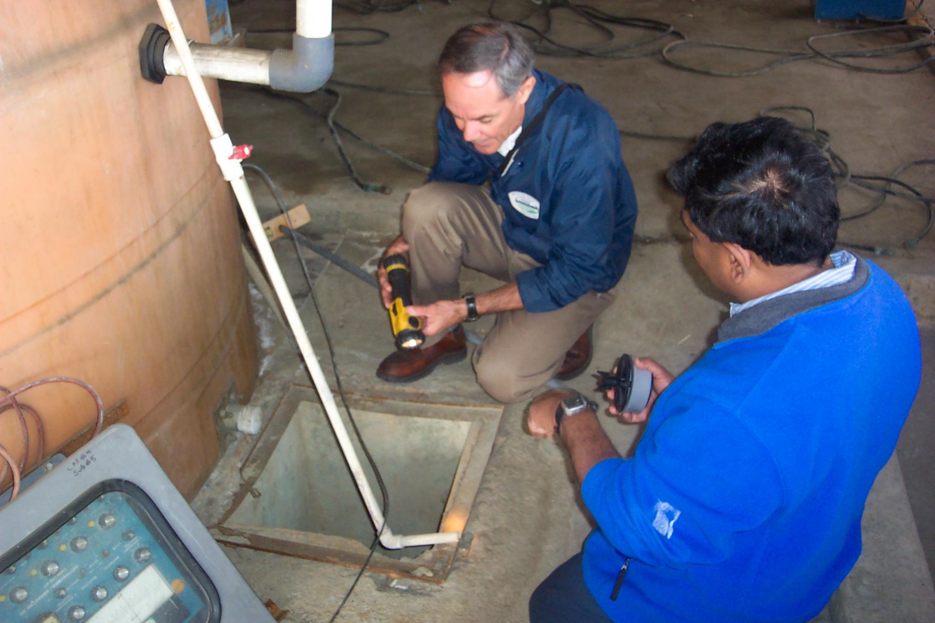 checking wastewater and monitoring equipment at a sample box